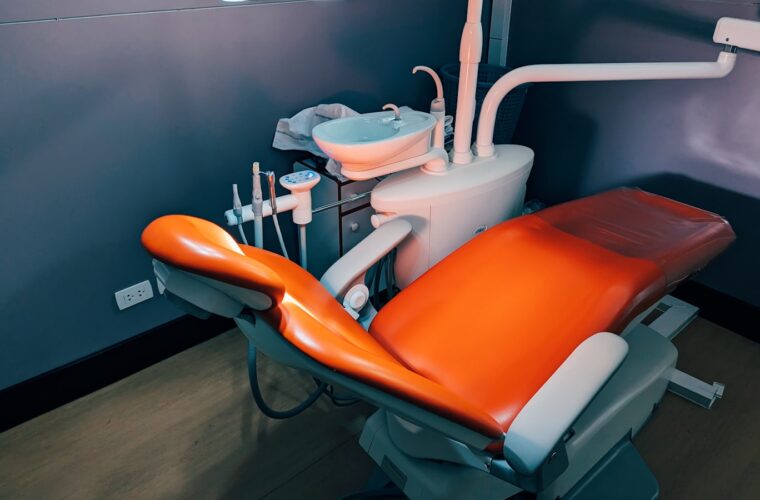 A dentist working carefully with a patient in the treatment chair