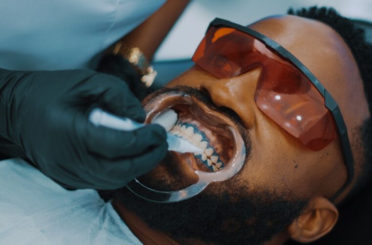 A dental hygienist cleaning a patient's teeth